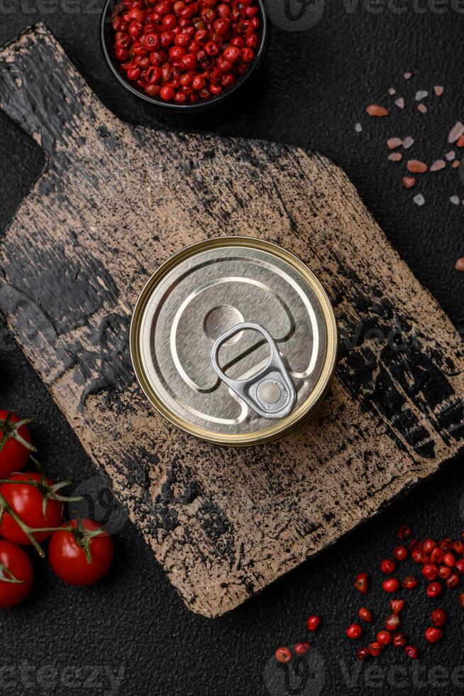 Round metal can with canned fish or meat with a key photo