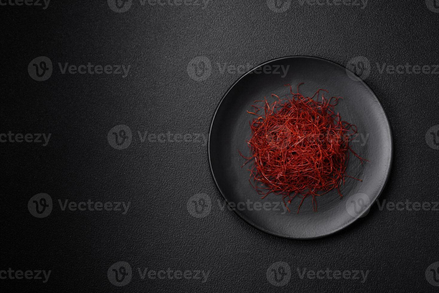 Red thin hot chili threads on a dark background photo