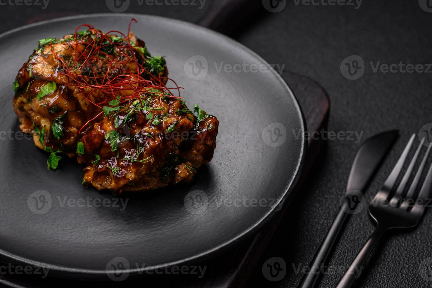 Delicious juicy fried chicken in teriyaki sauce with salt, spices, herbs and sesame seeds photo