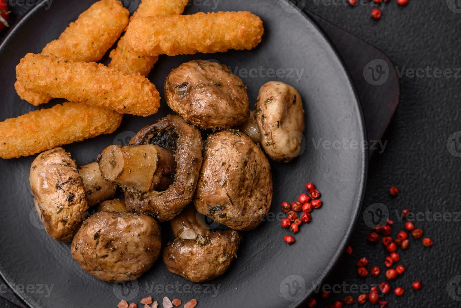 Delicious juicy whole champignons baked on the grill with salt and spices photo