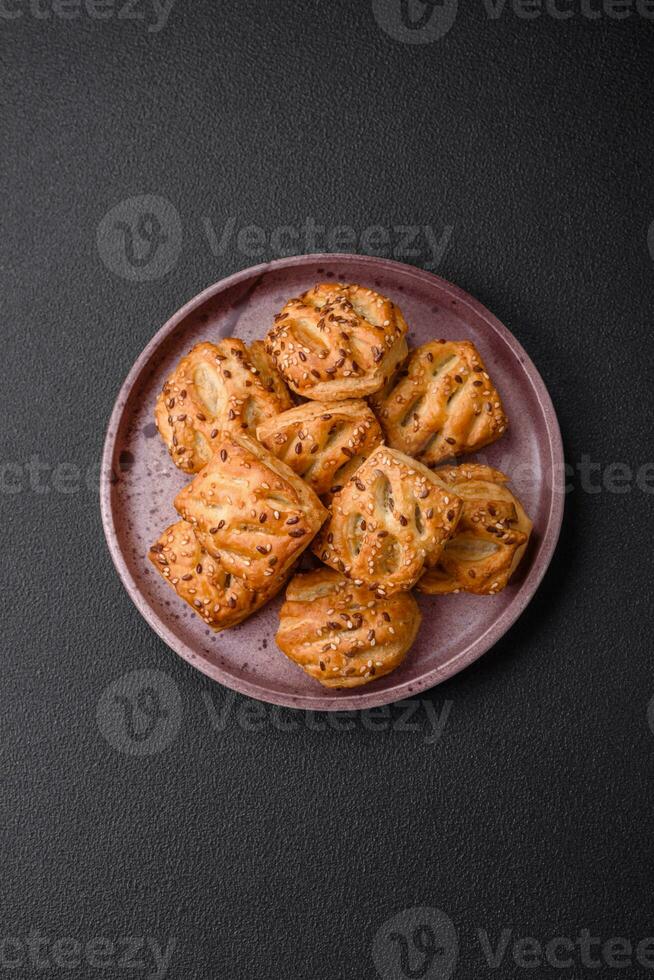Delicious crispy mini puffs with sausage or meat with salt, thyme and sesame photo