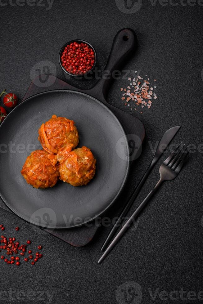 Delicious fresh meatballs from minced meat or fish with tomato sauce photo