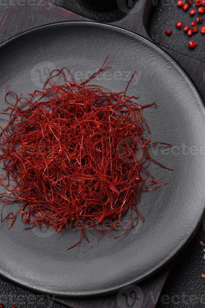 Red thin hot chili threads on a dark background photo