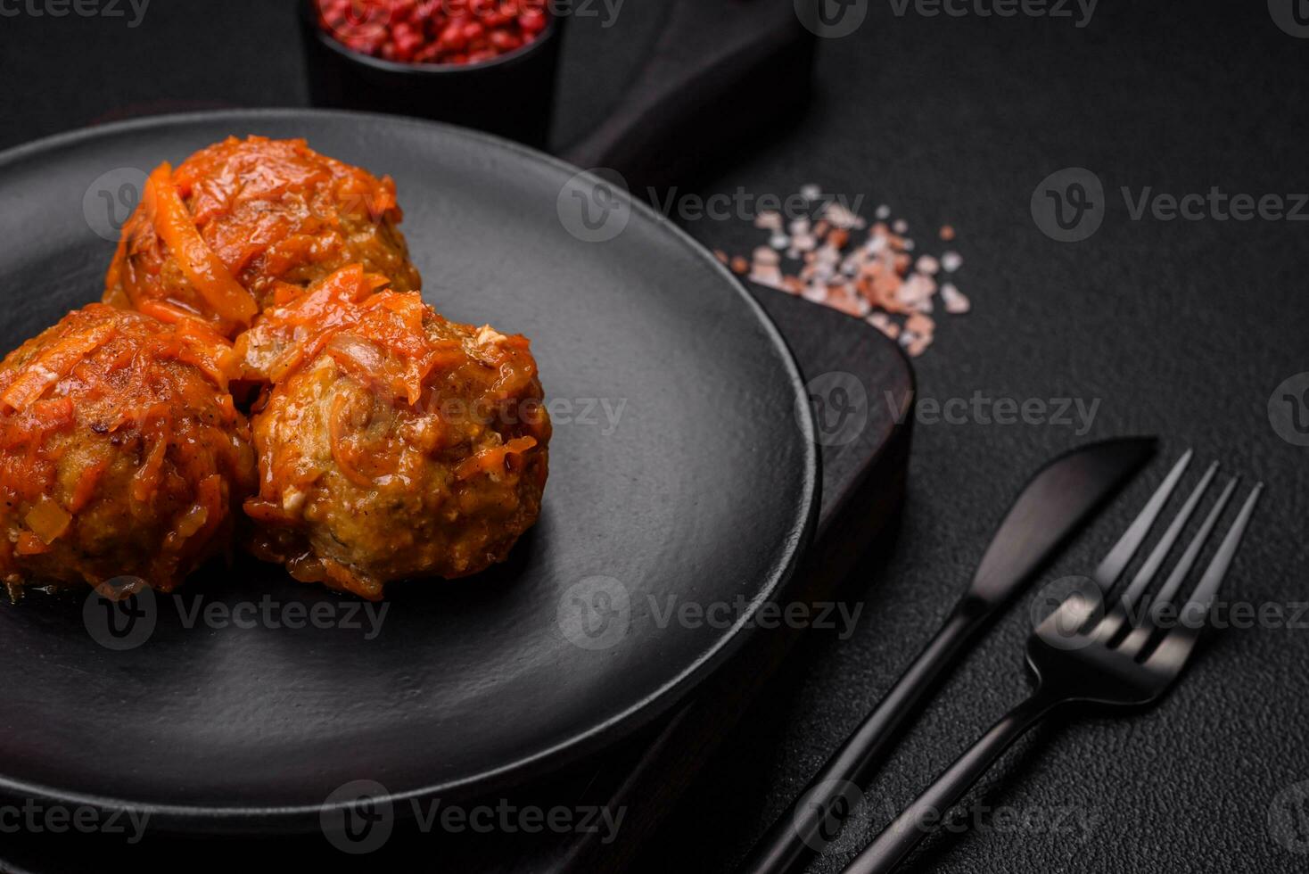 Delicious fresh meatballs from minced meat or fish with tomato sauce photo