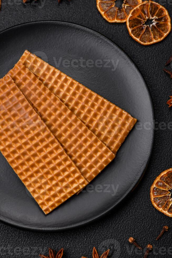 Delicious sweet crispy rectangular waffles on a ceramic plate photo