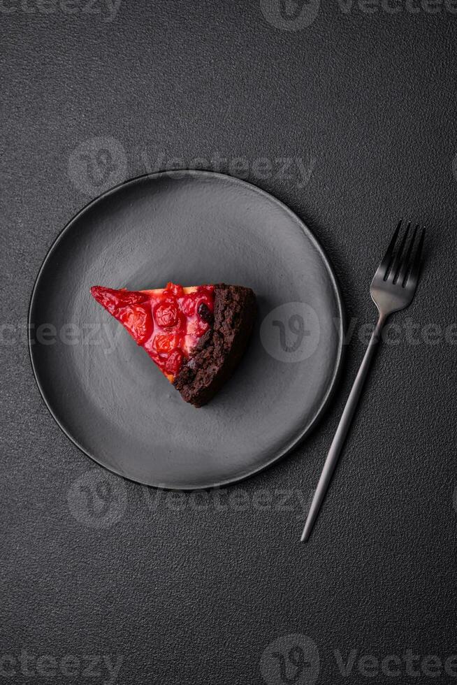 Beautiful tasty sweet slice of cheesecake with cherry on a ceramic plate photo