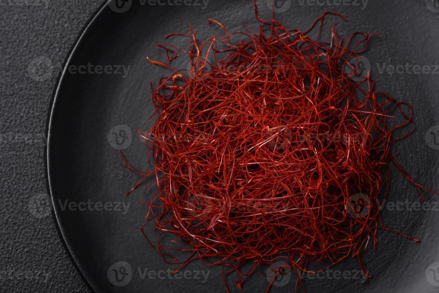 Red thin hot chili threads on a dark background photo