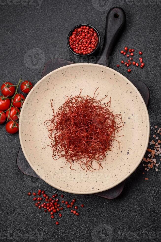 Red thin hot chili threads on a dark background photo