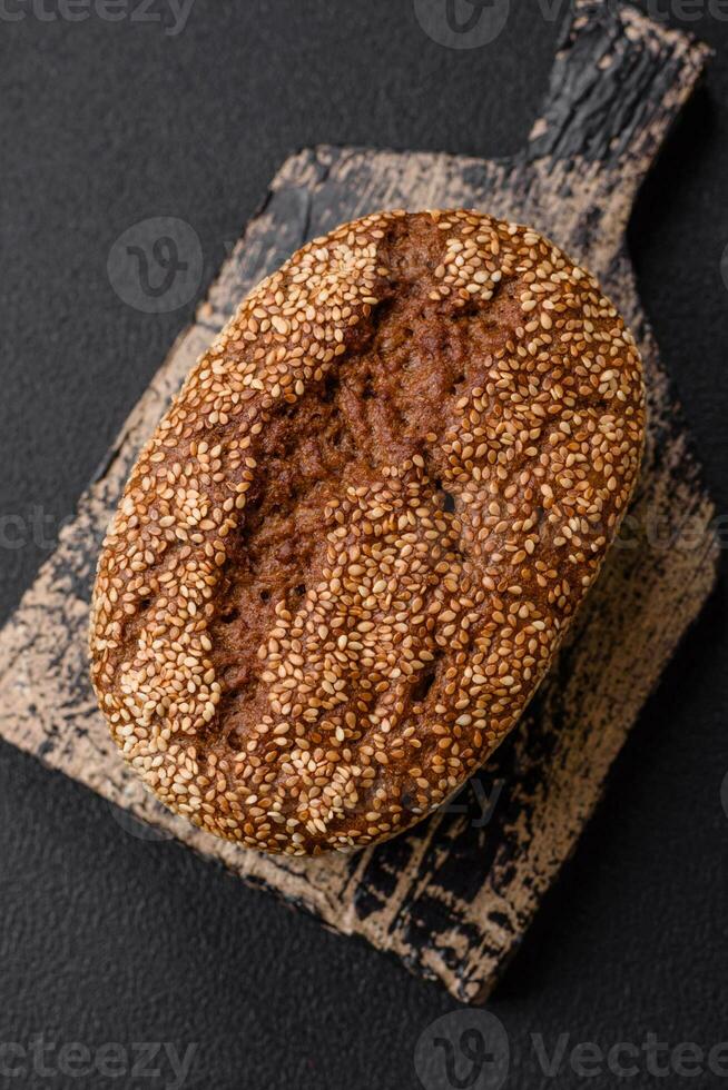 Delicious fresh crispy brown bread with seeds and grains photo