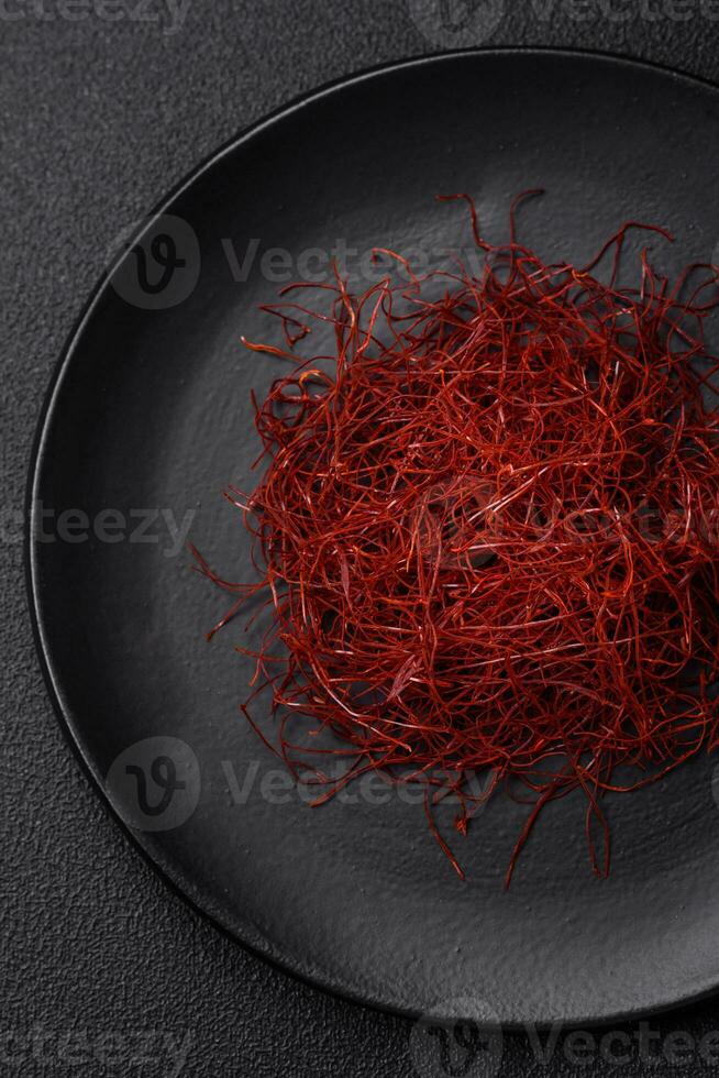 Red thin hot chili threads on a dark background photo