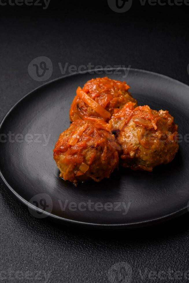 Delicious fresh meatballs from minced meat or fish with tomato sauce photo