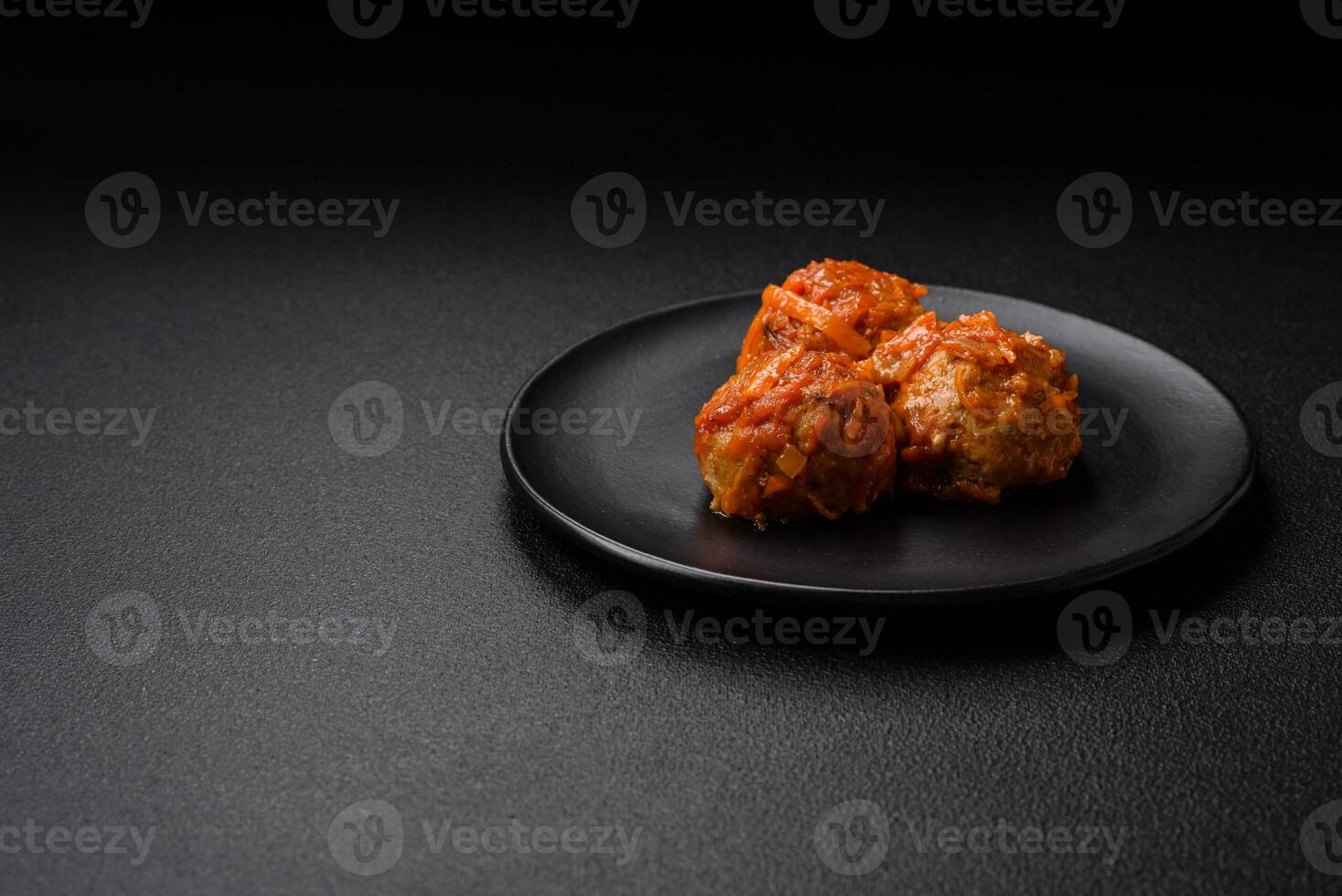 Delicious fresh meatballs from minced meat or fish with tomato sauce photo