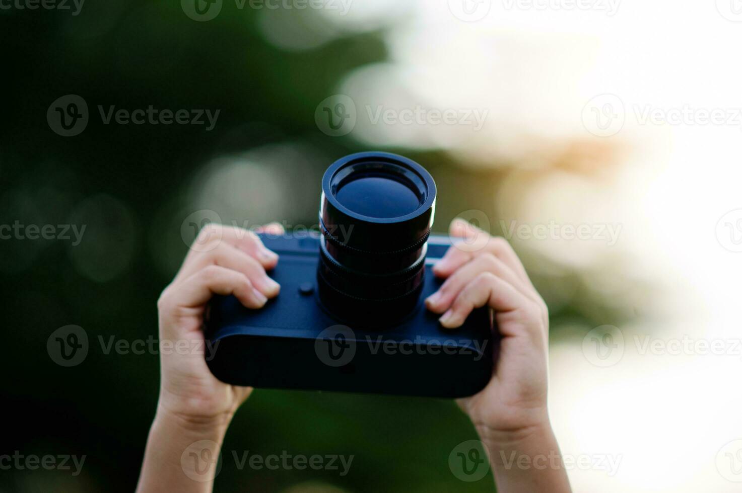 Take pictures with a mirrorless camera. Little girl practicing nature photography little photographer the joy of taking pictures photo