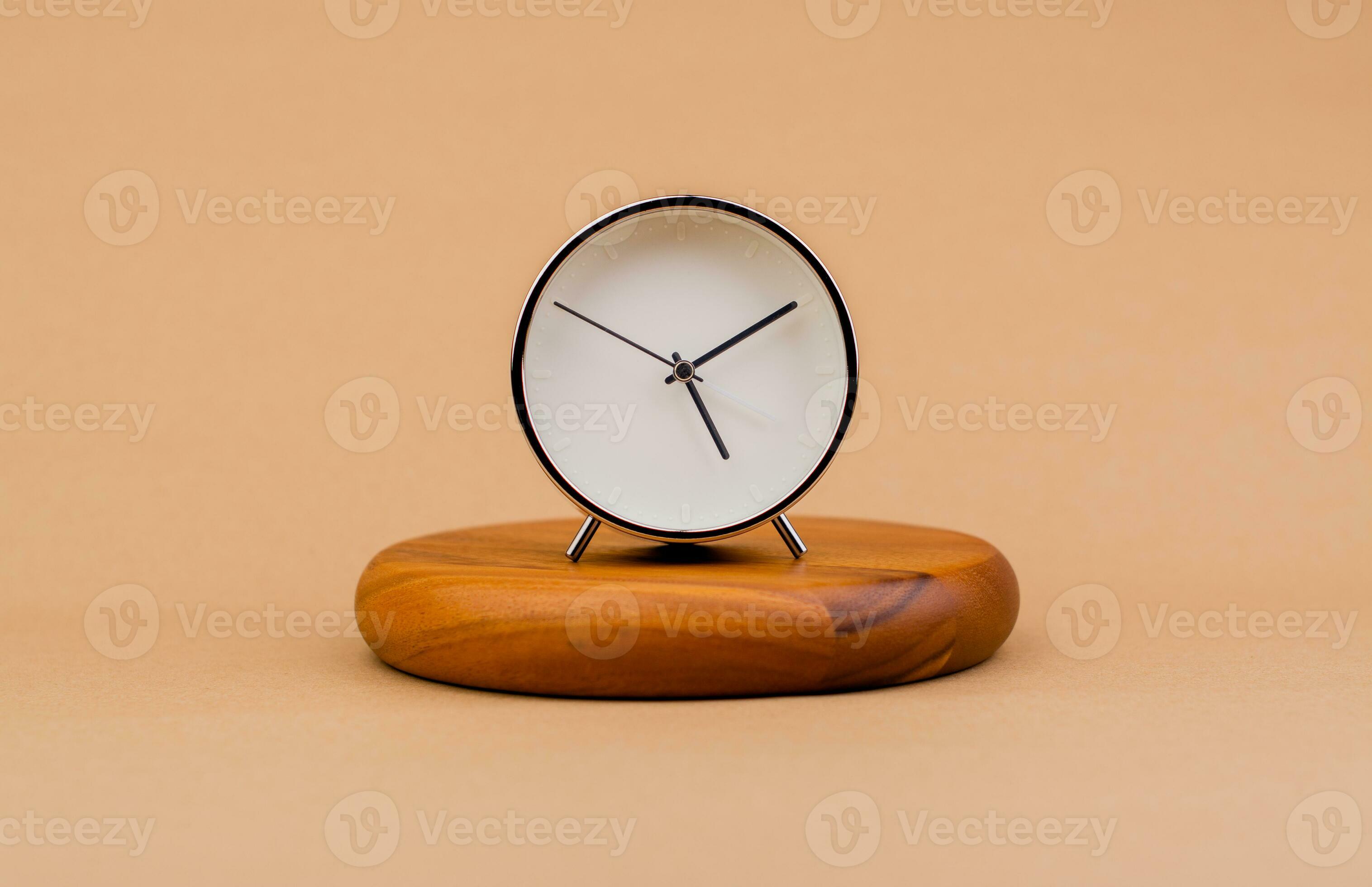 Modern alarm clock placed on a wooden plan Time clock, notifications