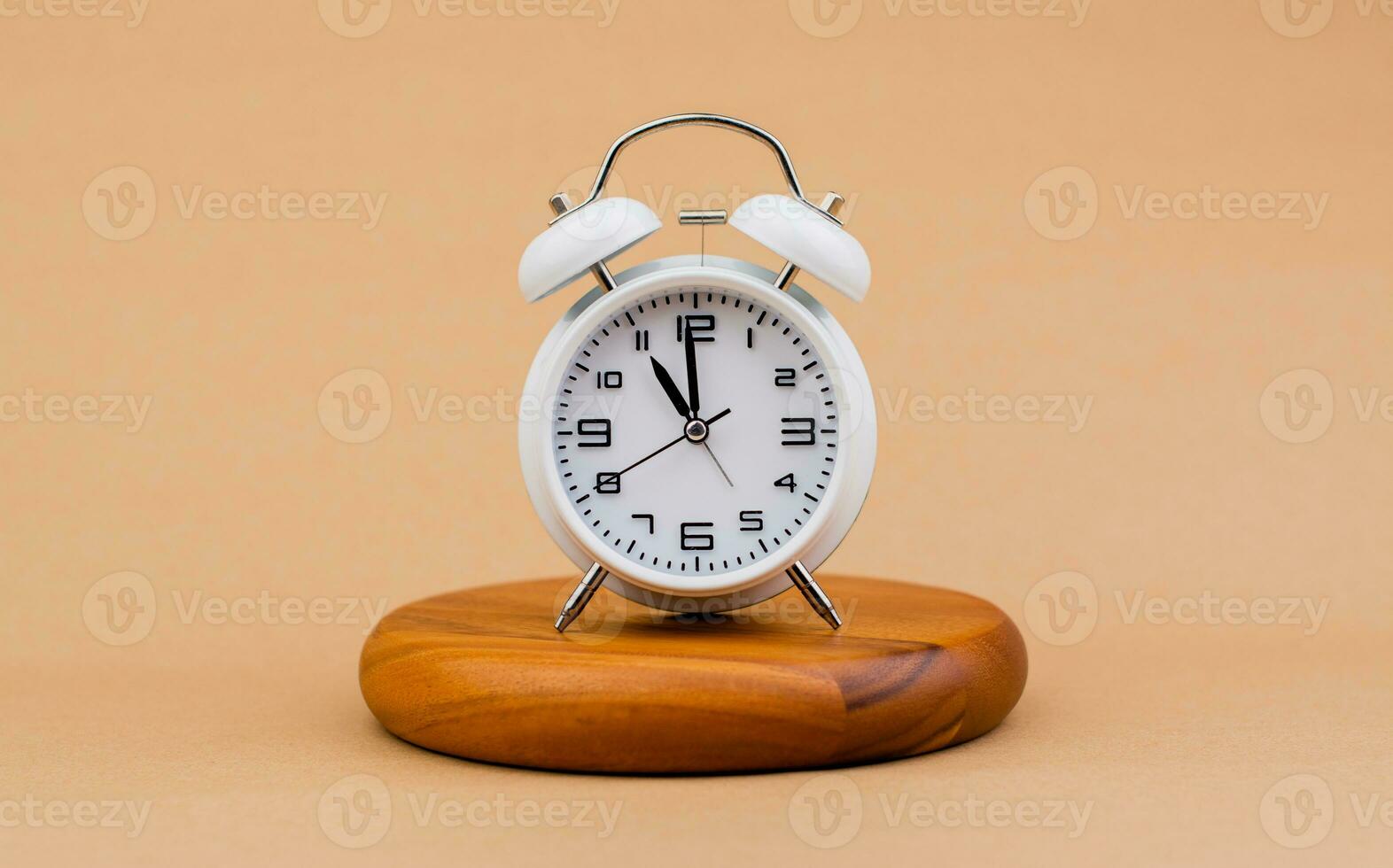 Modern alarm clock placed on a wooden plan Time clock, notifications, alarms time and work concept photo