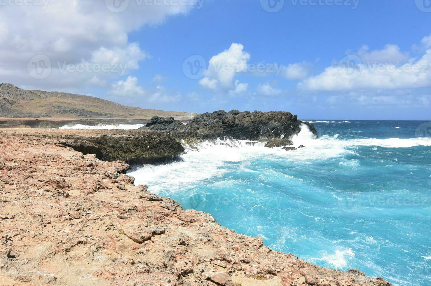 Crashing Ocean Waves on Aruba's Rocky Eastern Coast photo