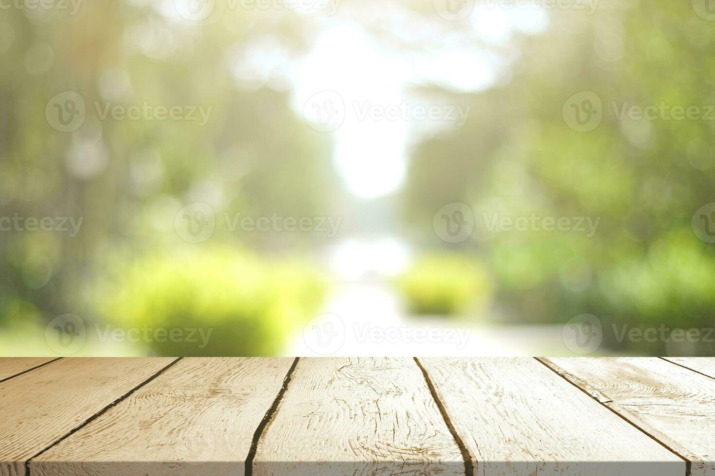 Empty wooden table with Blurred image of abstract circular green bokeh from nature style background. photo