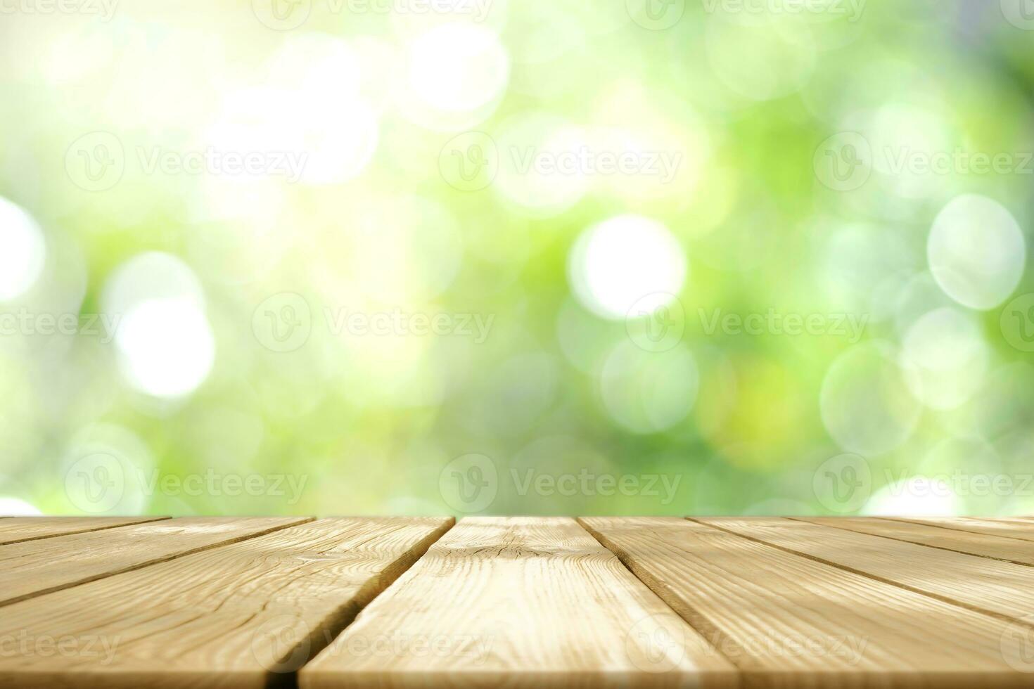 Empty wooden table with Blurred image of abstract circular green bokeh from nature style background. photo