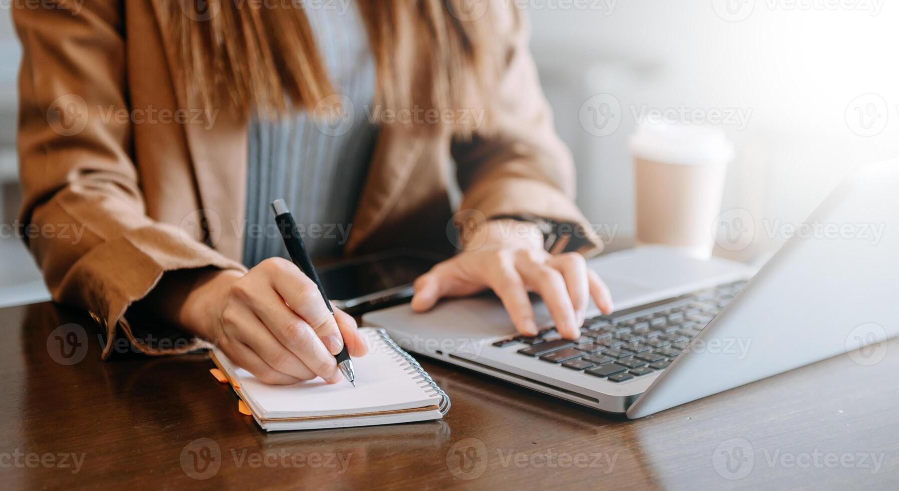 businesswoman hand working with new modern computer and writing on the notepad strategy diagram as concept photo