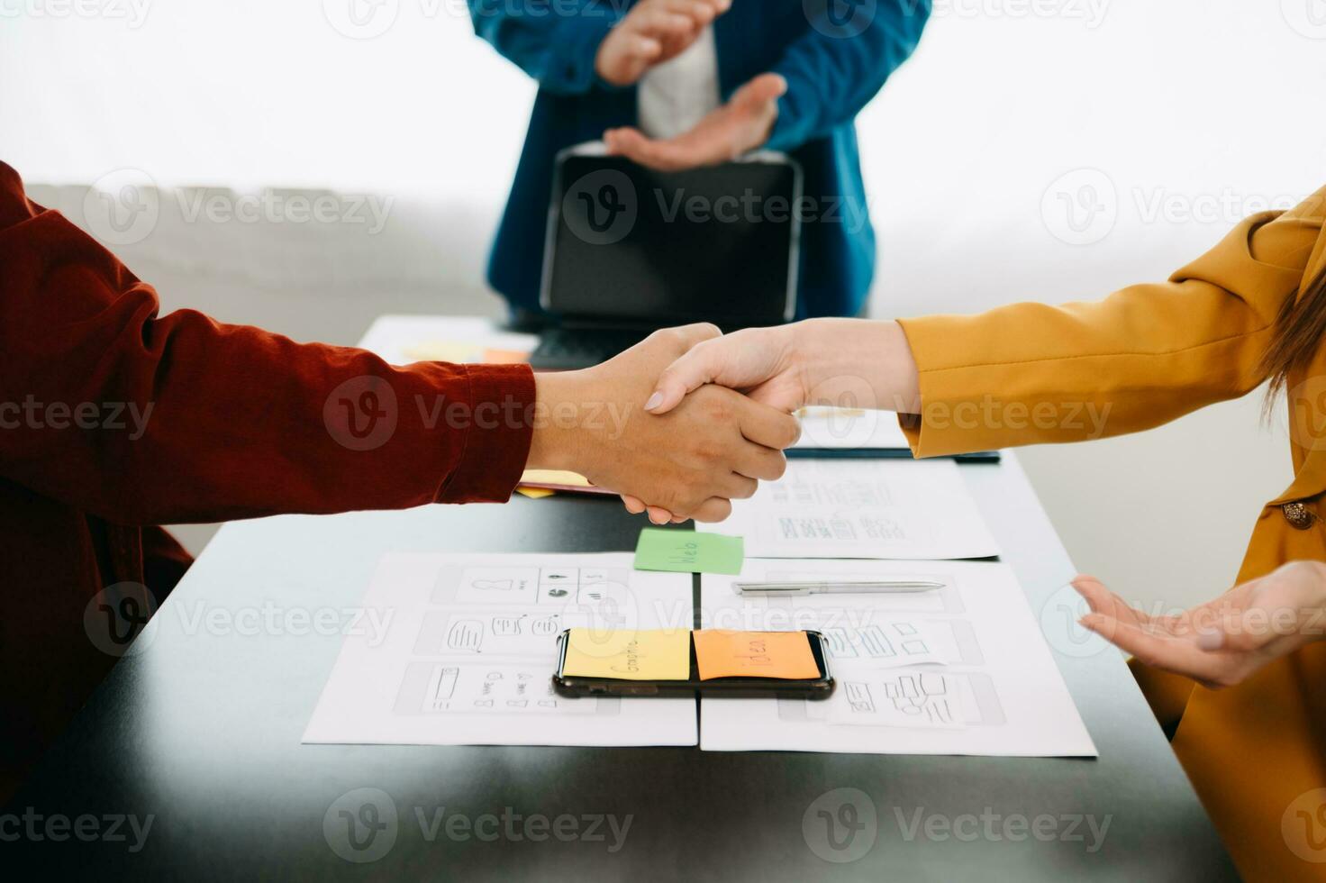 UX developer and ui designer brainstorming about mobile app interface wireframe design with customer breif and color code at modern office. photo