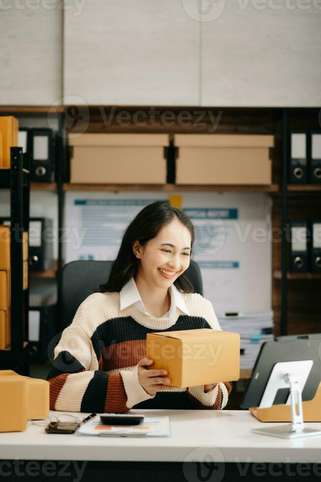 Beautiful Asian lady blogger showing clothes in front of the camera to recording vlog video live streaming photo