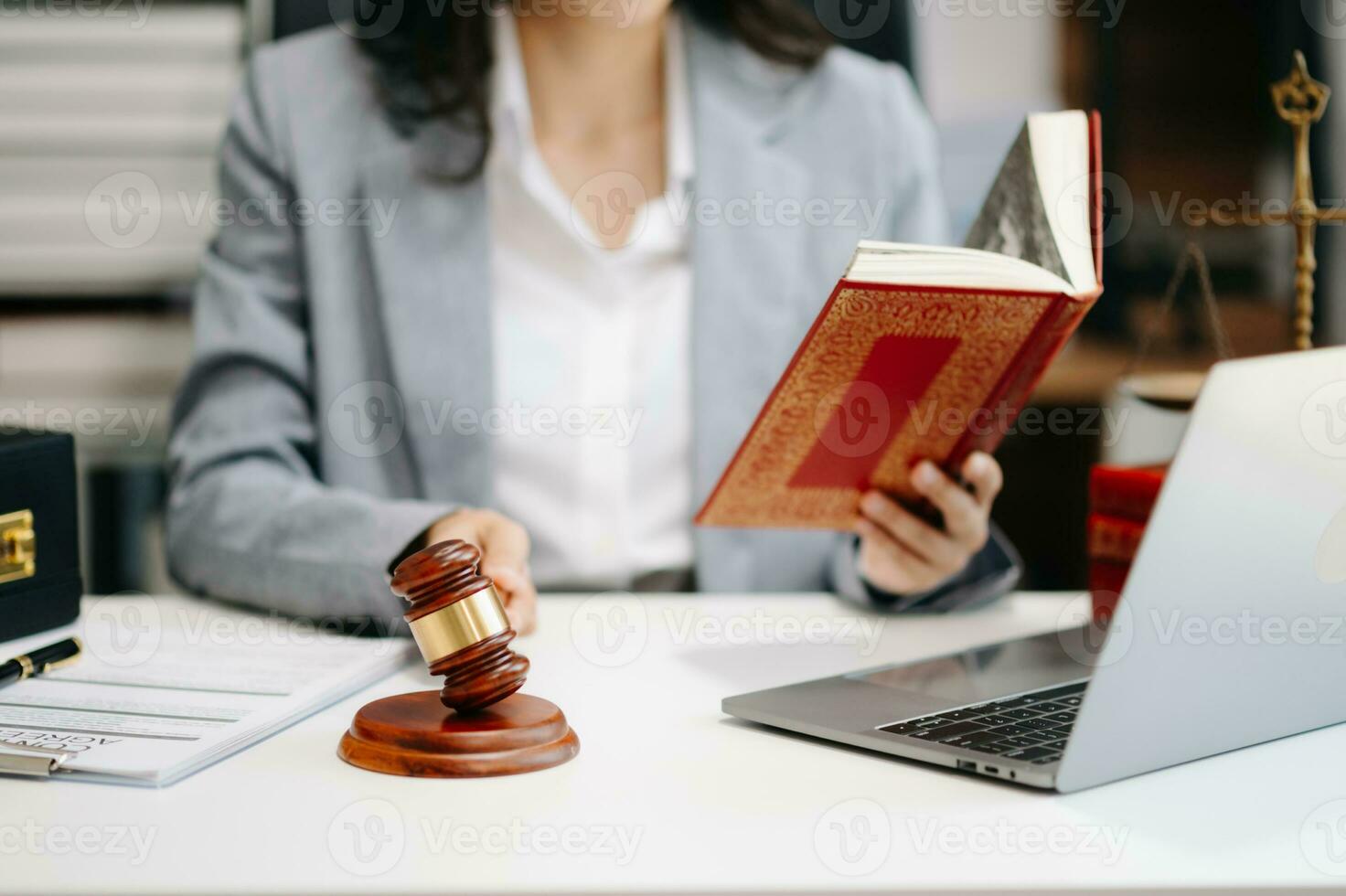 justice and law concept.law theme wooden desk, books, balance. Male judge in a courtroom the gavel,working with digital tablet computer on table photo