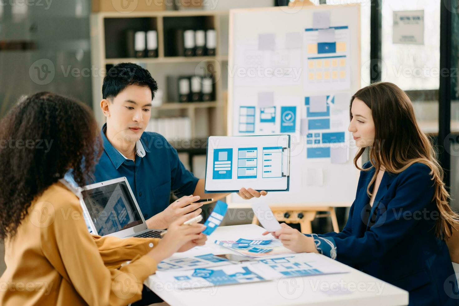 UX developer and ui designer brainstorming about mobile app interface wireframe design with customer breif and color code photo