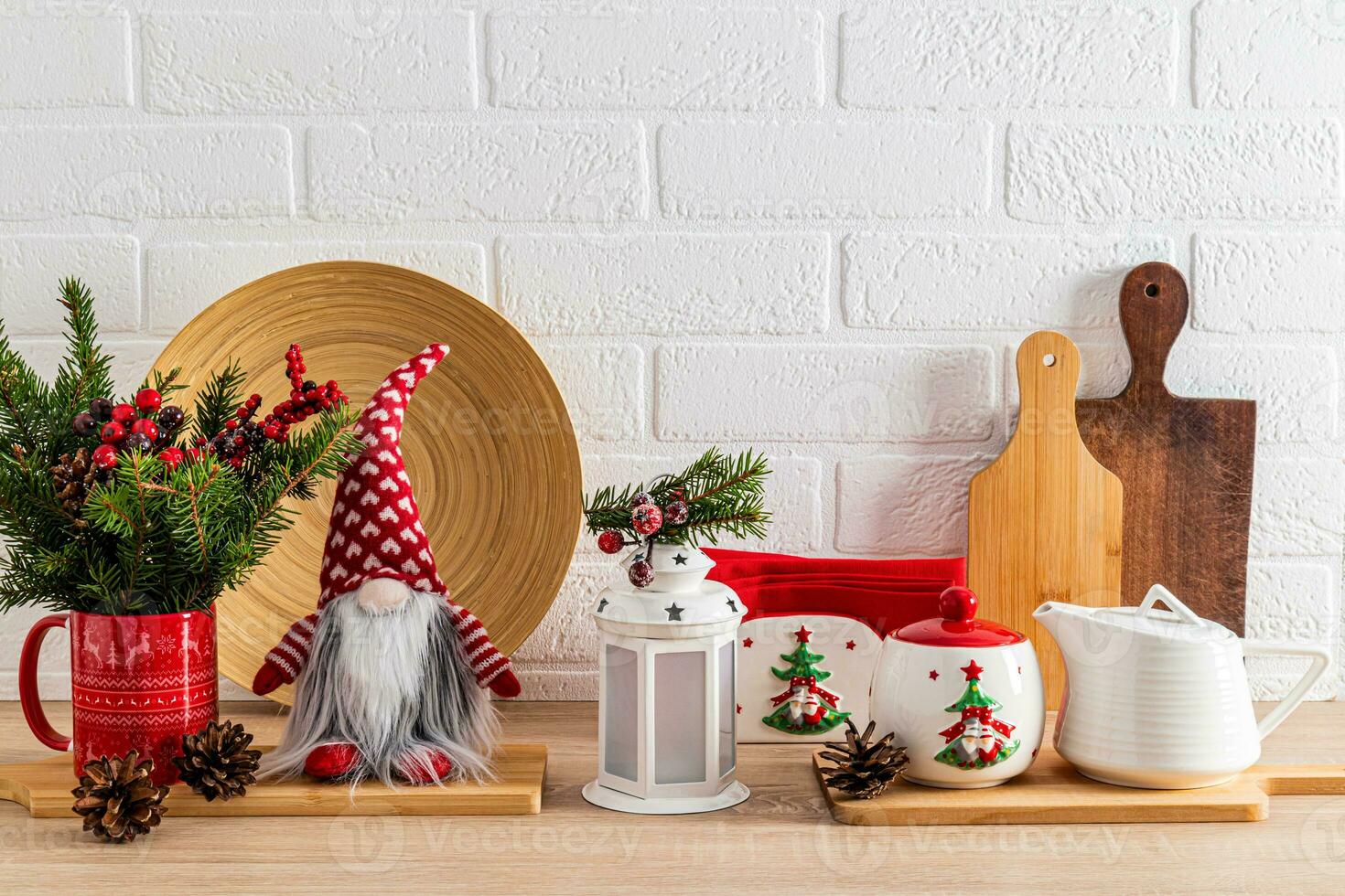 Chic kitchen background decorated with New Year's items, toys, dishes. White brick wall. Wooden countertop. Eco-friendly kitchen photo