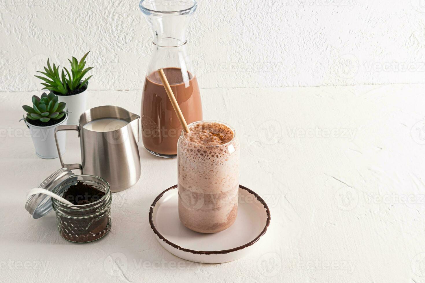 Beautiful modern glass with delicious aromatic coffee latte or cappuccino with ingredients for cooking on a white background. Plants. still life. photo