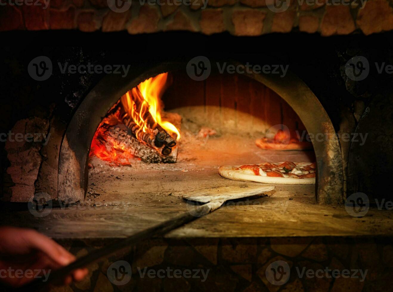 Baked tasty margherita pizza getting out of the oven photo