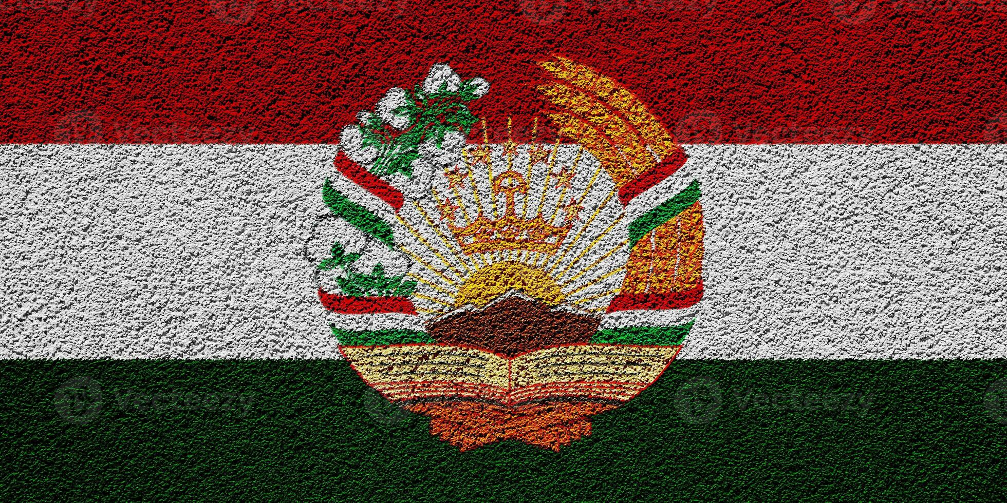 Flag and coat of arms of Republic of Tajikistan on a textured background. Concept collage. photo