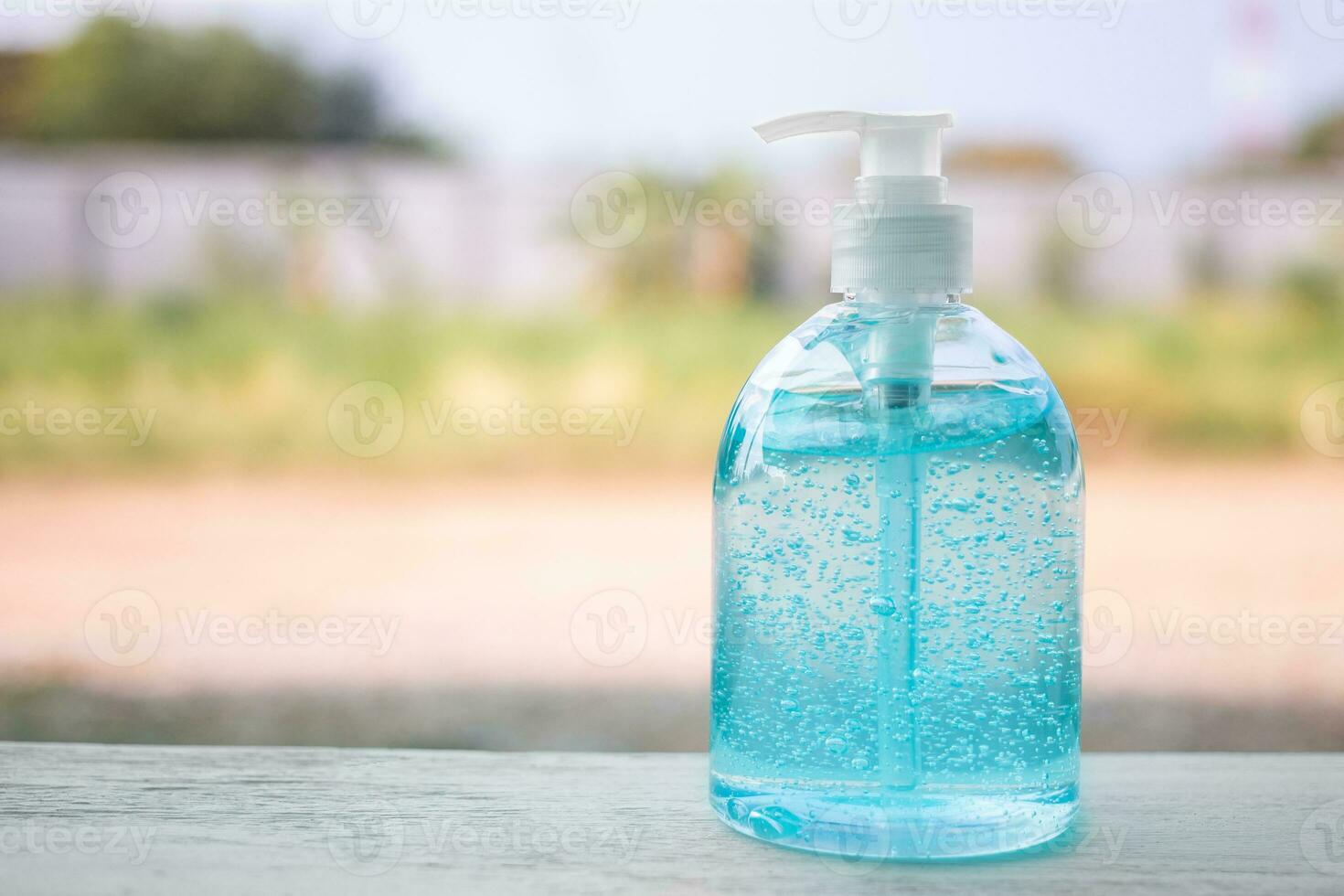 Plastic bottle pump with alcohol hand gel. Hand Sanitizer Antibacterial Cleansing Gel. photo
