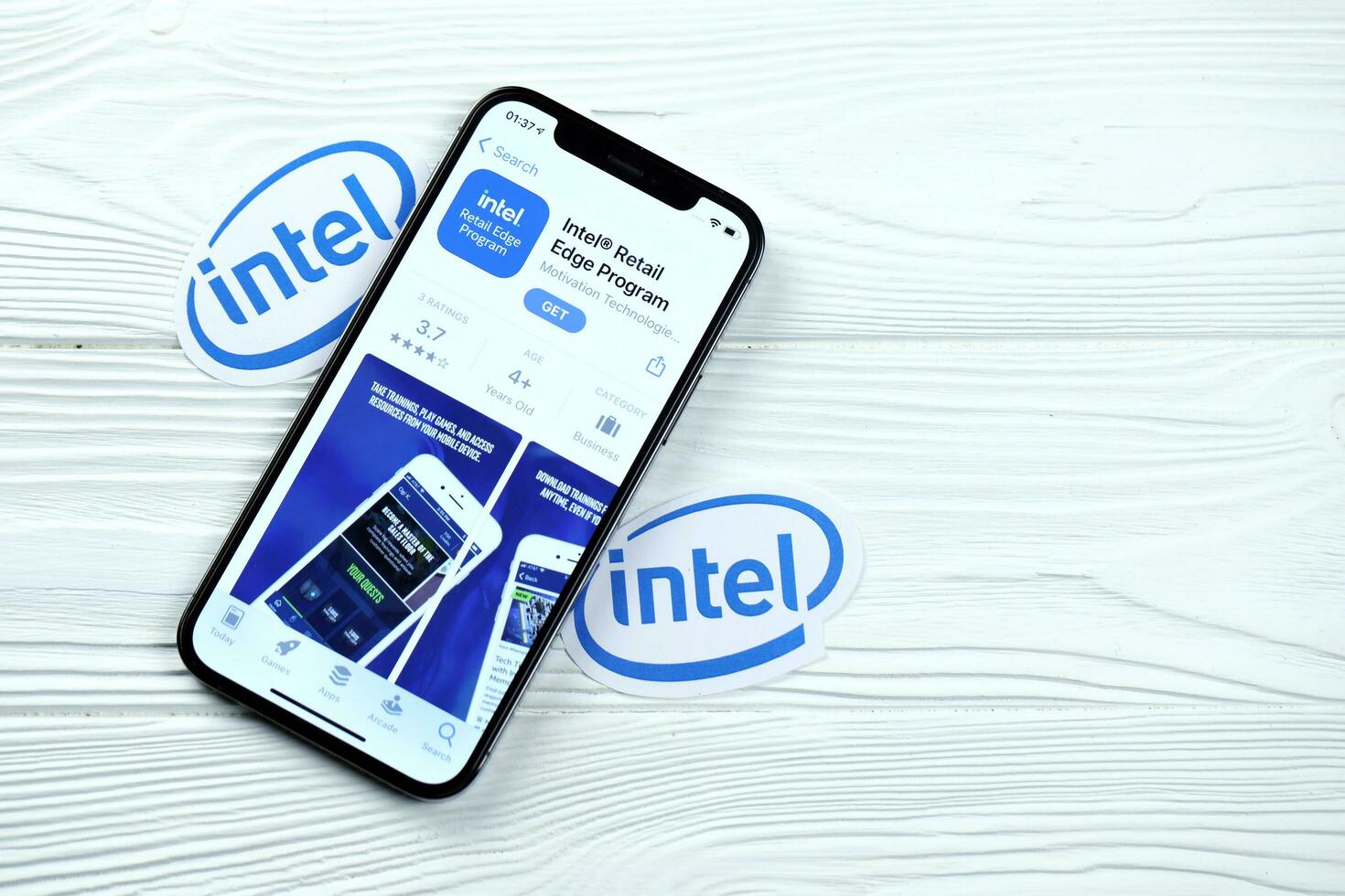 KHARKOV, UKRAINE - MARCH 5, 2021 Intel icon and application from App store on iPhone 12 pro display screen on white table photo
