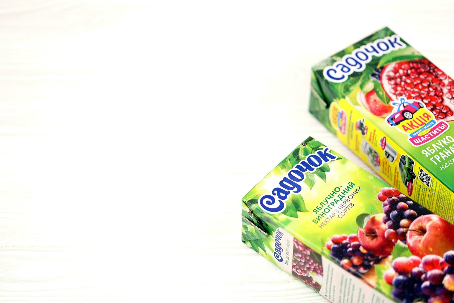 KHARKOV, UKRAINE - JULY 2, 2021 Sadochok Apple and grape nectar from red varieties and apple with pomegranate juice tetra-packs photo