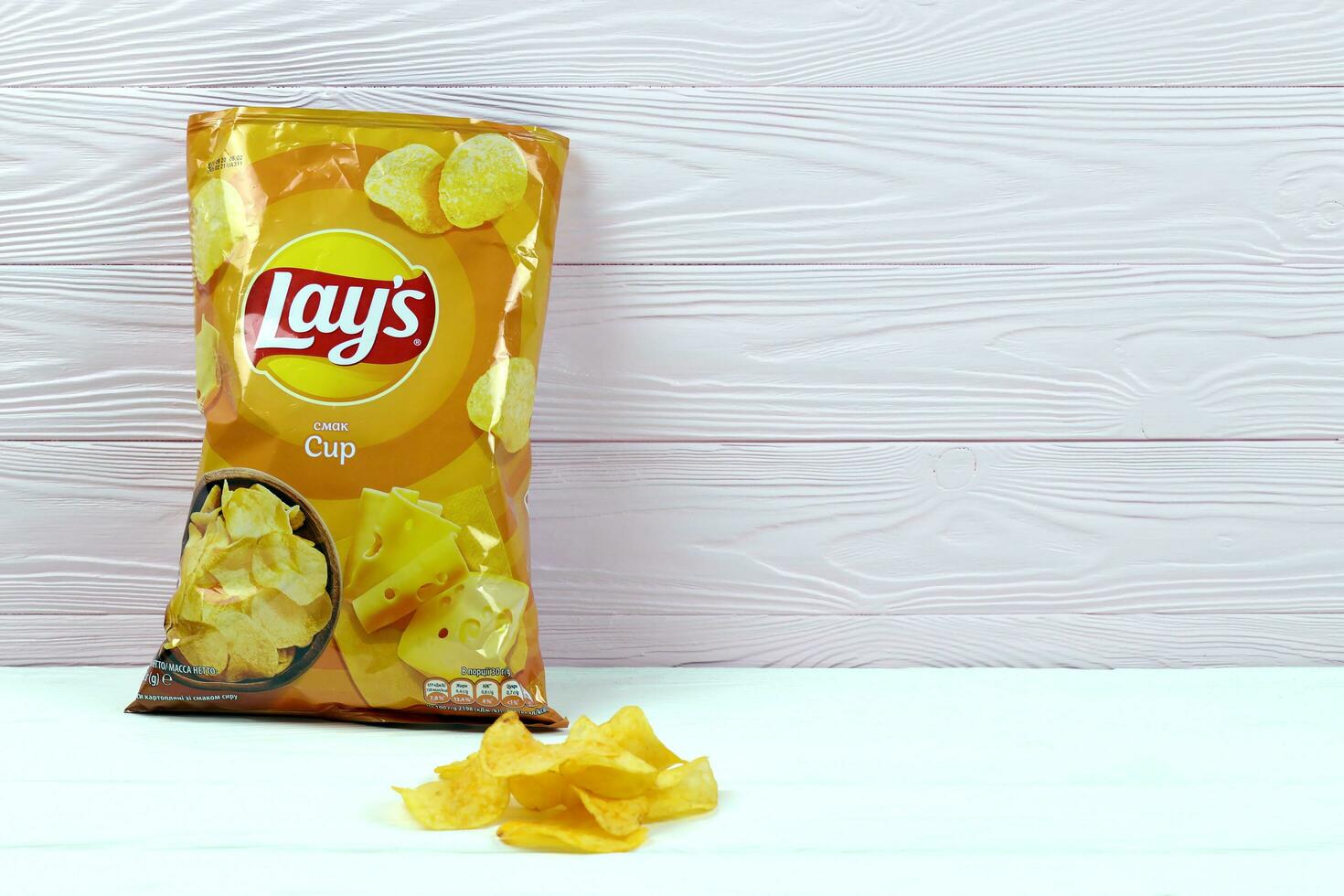 KHARKOV, UKRAINE - JANUARY 3, 2021 Lays potato chips with cheese flavour and original lays logo in middle of package. Worldwide famous brand of potato chips photo