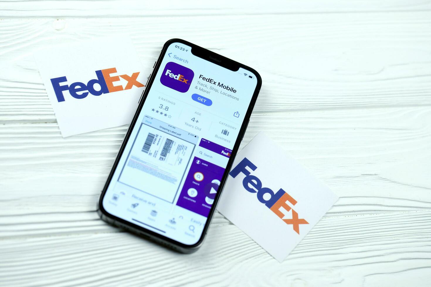 KHARKOV, UKRAINE - MARCH 5, 2021 Fedex icon and application from App store on iPhone 12 pro display screen on white table photo