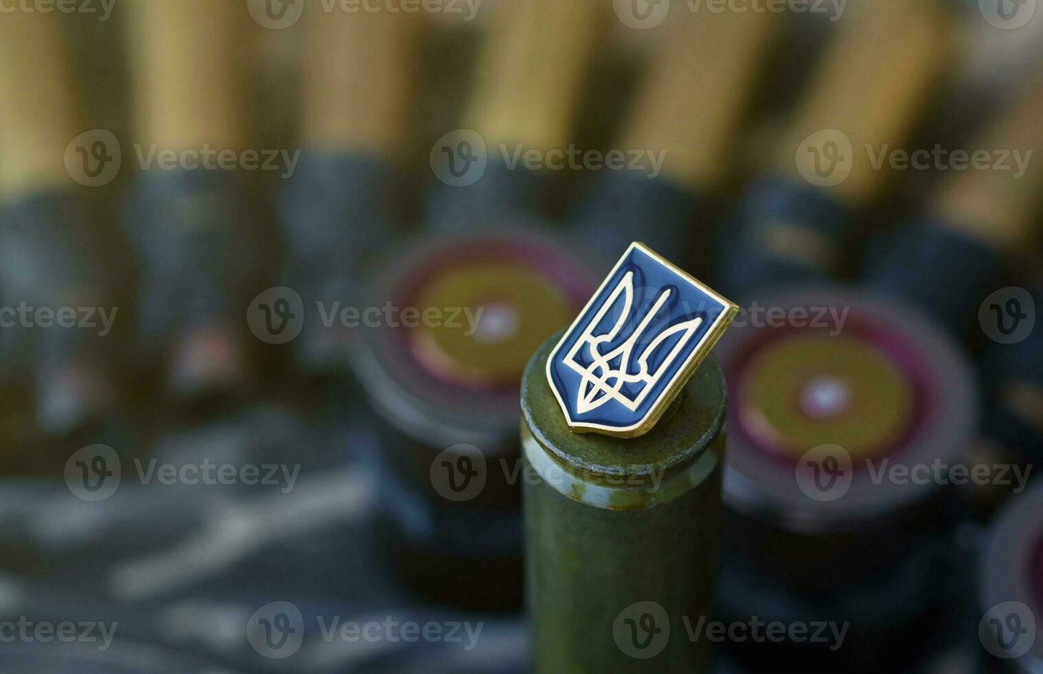 Ukrainian symbol on machine gun belt lies on ukrainian pixeled military camouflage photo