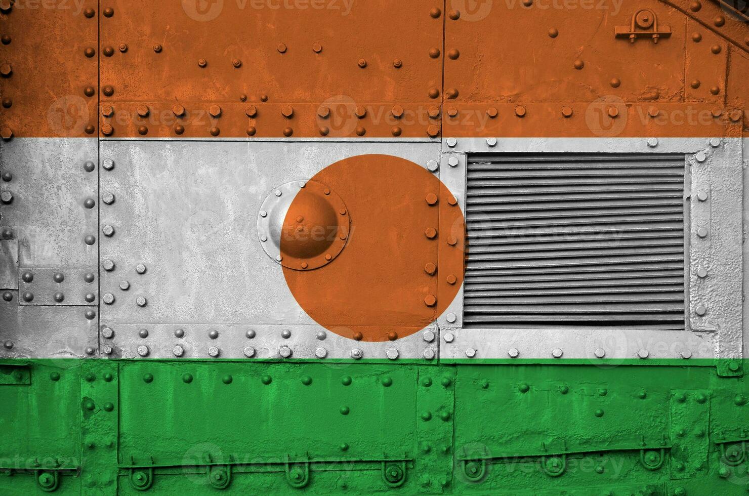 Niger flag depicted on side part of military armored tank closeup. Army forces conceptual background photo