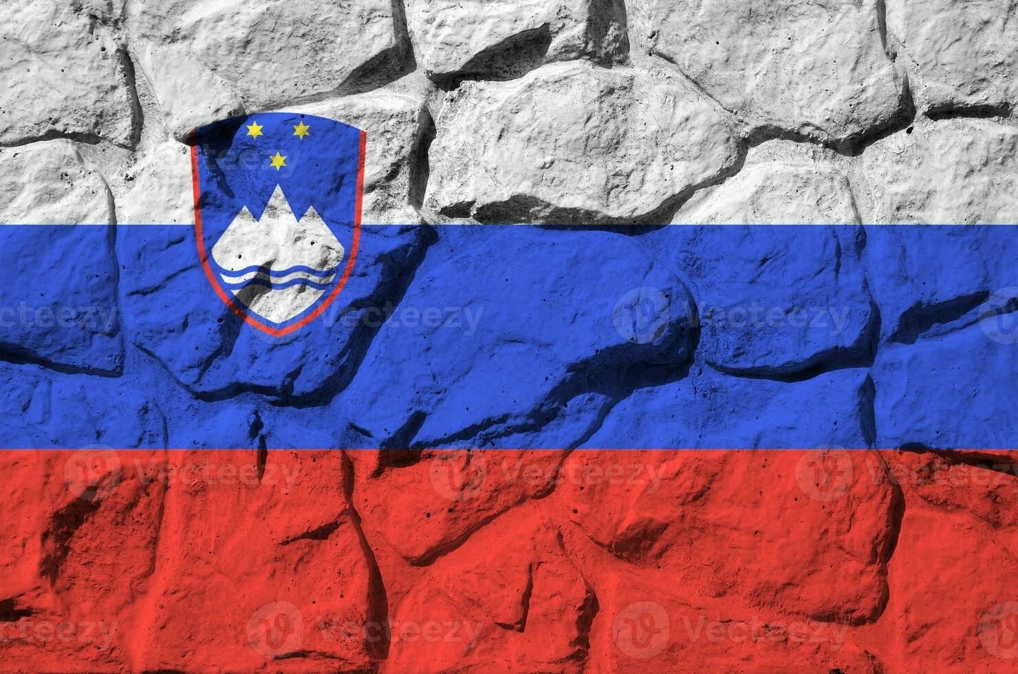 Slovenia flag depicted in paint colors on old stone wall closeup. Textured banner on rock wall background photo