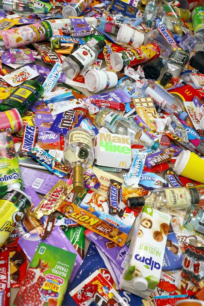 KHARKOV, UKRAINE - AUGUST 10, 2021 Big pile of various wrappings and empty disposable packages and cups from famous branded food production photo