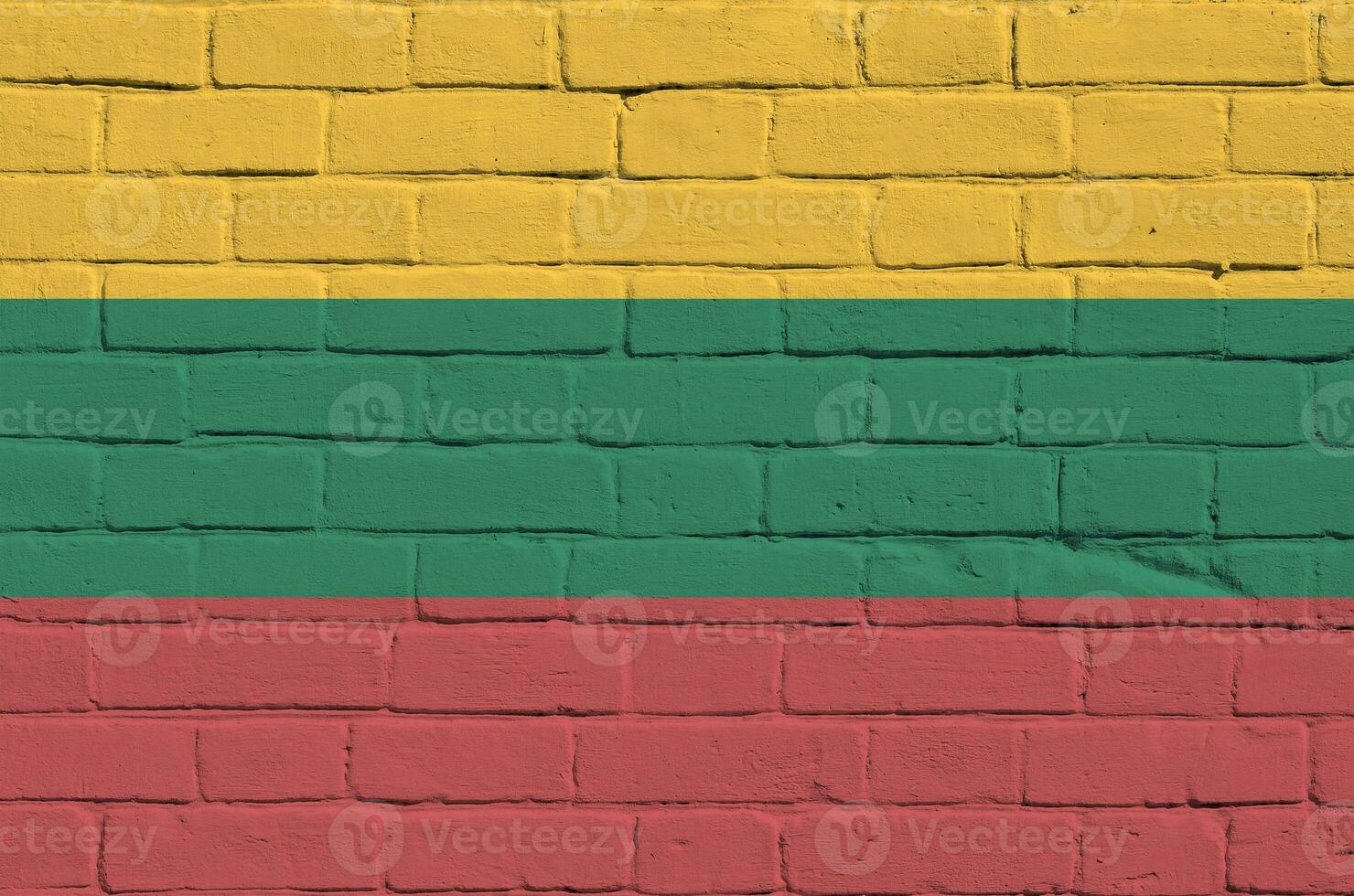 Lithuania flag depicted in paint colors on old brick wall. Textured banner on big brick wall masonry background photo