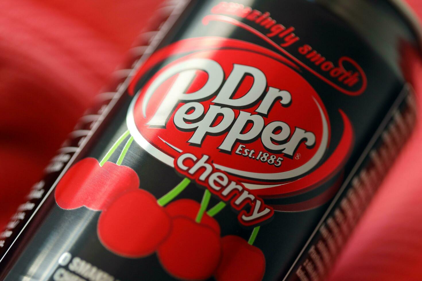 KYIV, UKRAINE - JULY 7, 2023 Dr Pepper cherry drink can on red background photo