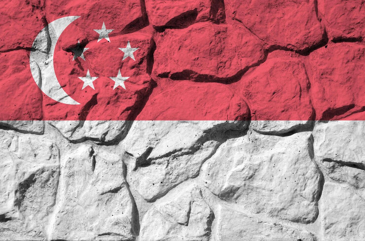 Singapore flag depicted in paint colors on old stone wall closeup. Textured banner on rock wall background photo