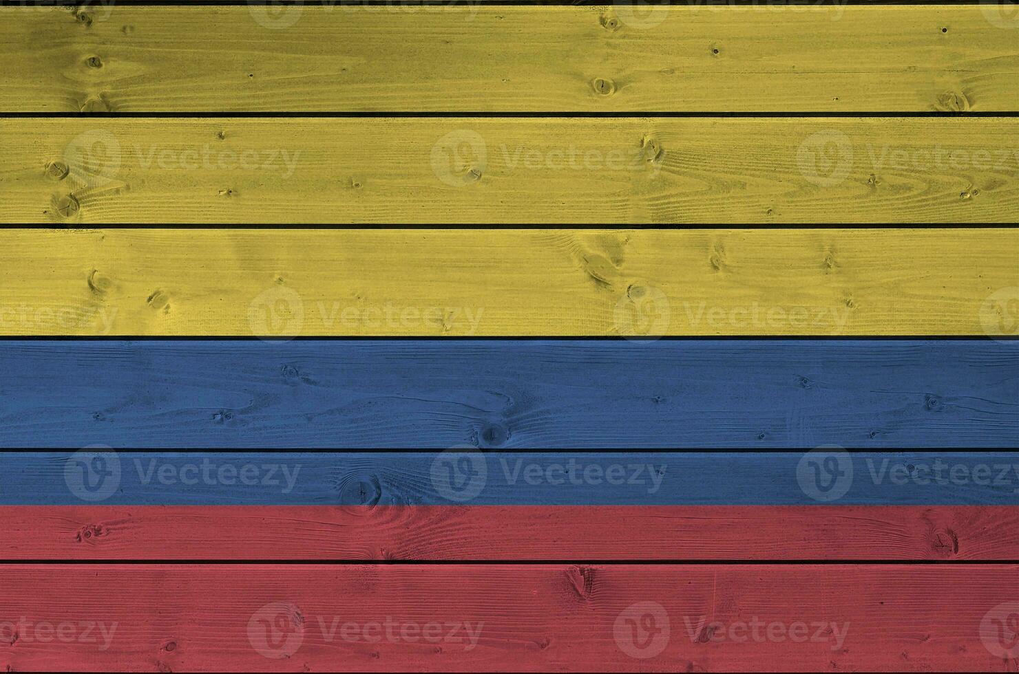 Colombia flag depicted in bright paint colors on old wooden wall. Textured banner on rough background photo