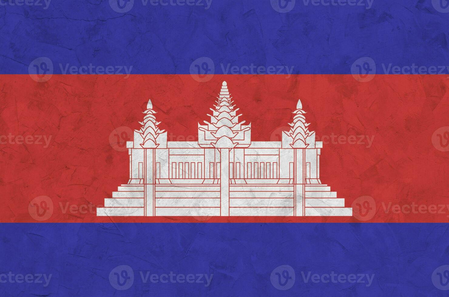 Cambodia flag depicted in bright paint colors on old relief plastering wall. Textured banner on rough background photo