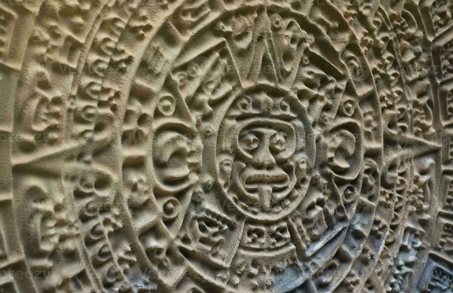 Ancient Mayan Calendar or Aztec calendar with rough relief surface photo
