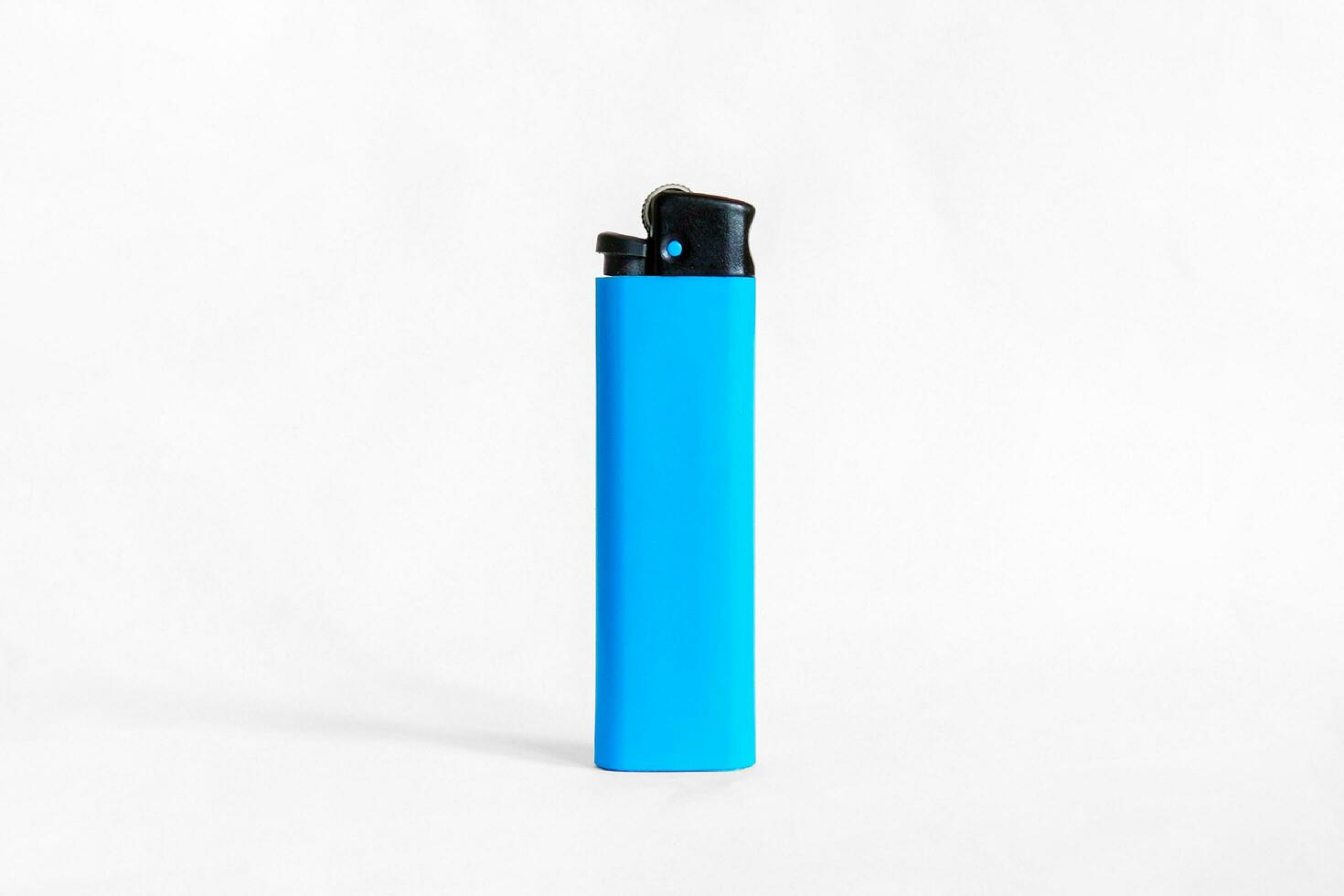 Blue plastic lighter on white background photo