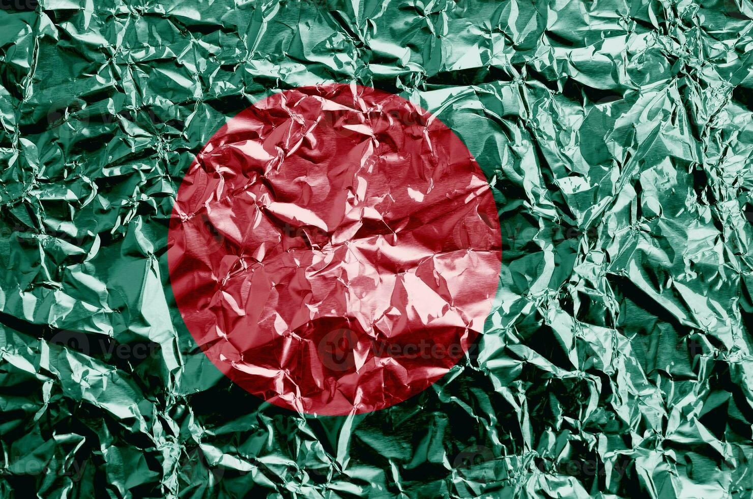 Bangladesh flag depicted in paint colors on shiny crumpled aluminium foil closeup. Textured banner on rough background photo