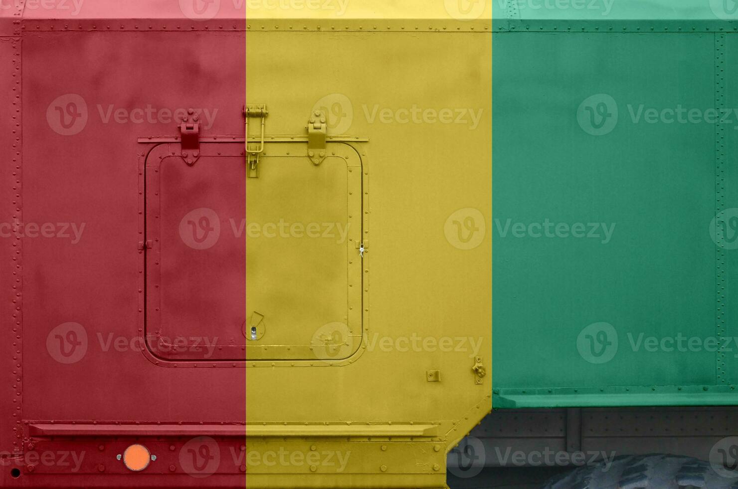 Guinea flag depicted on side part of military armored truck closeup. Army forces conceptual background photo