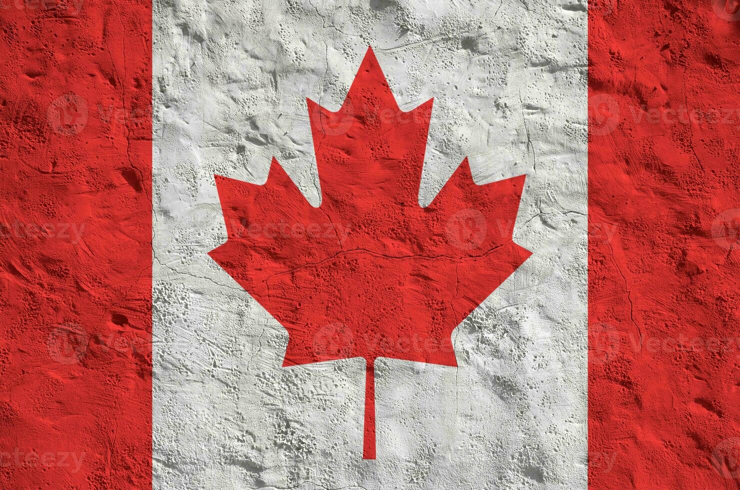 Canada flag depicted in bright paint colors on old relief plastering wall. Textured banner on rough background photo